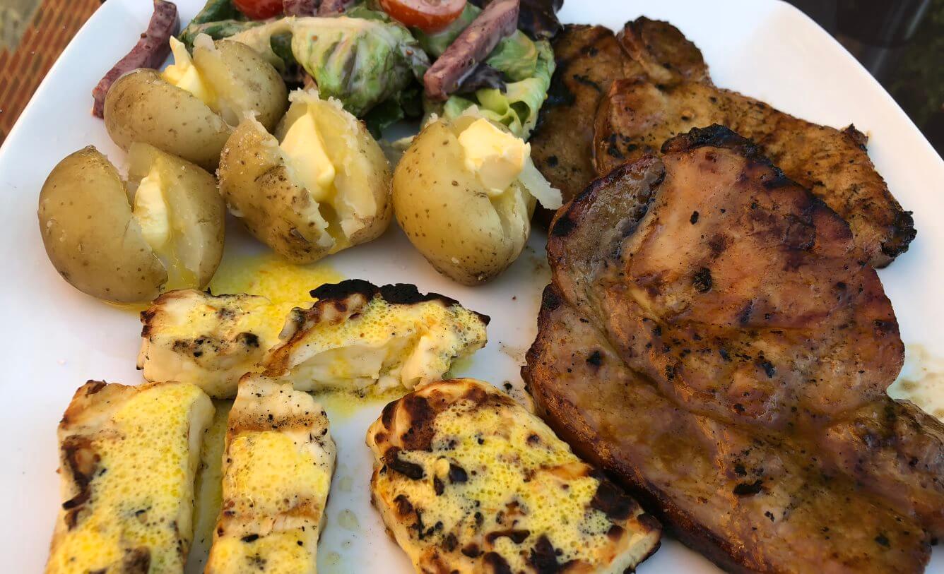Marinated pork loin steaks, served up with halloumi, salad and steamed jersey royals